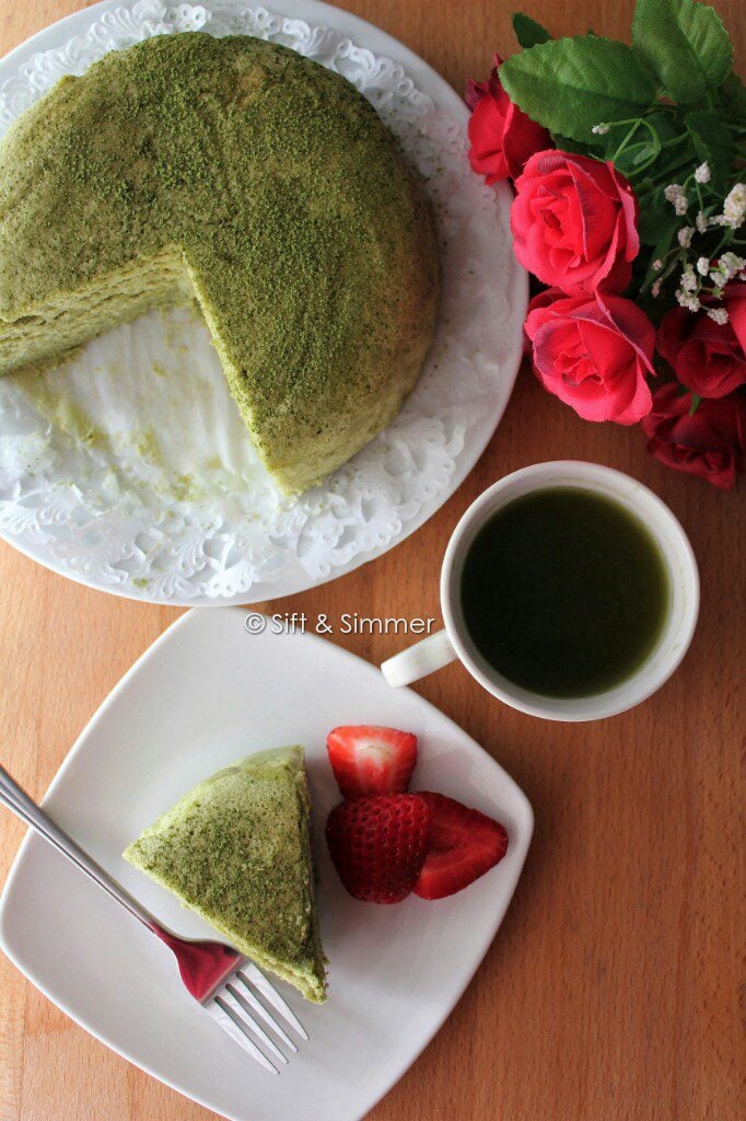 Matcha Cotton Cheesecake on plate with fork, tea cup.