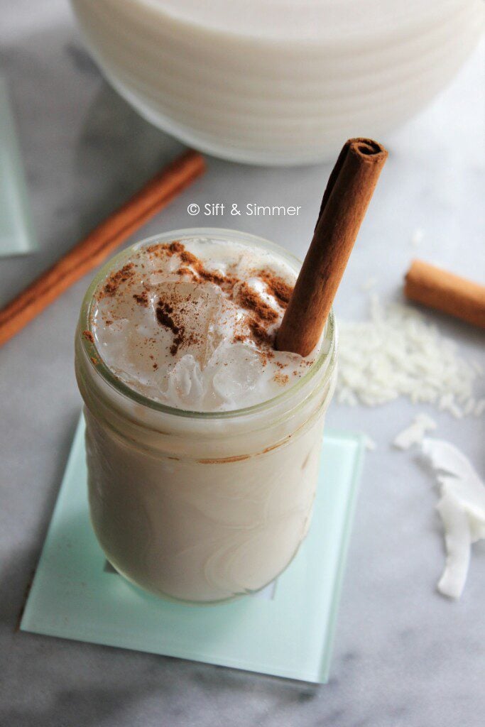Mexican Coconut Horchata in glass with cinnamon stick.