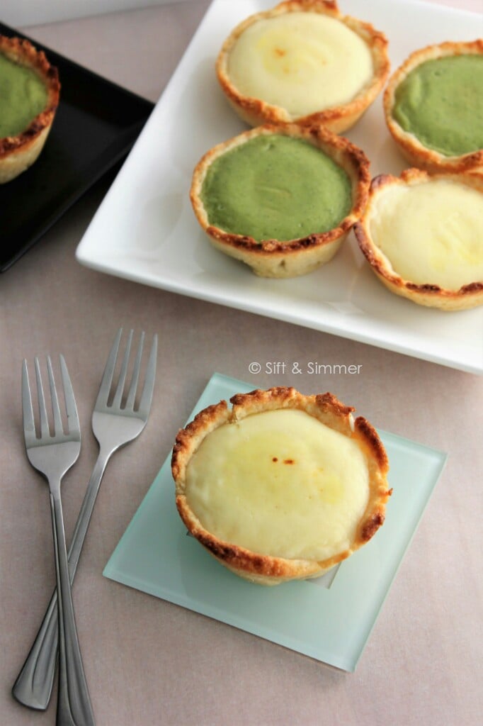 Whole Molten Lava Cheese Tart on coaster with forks on side.