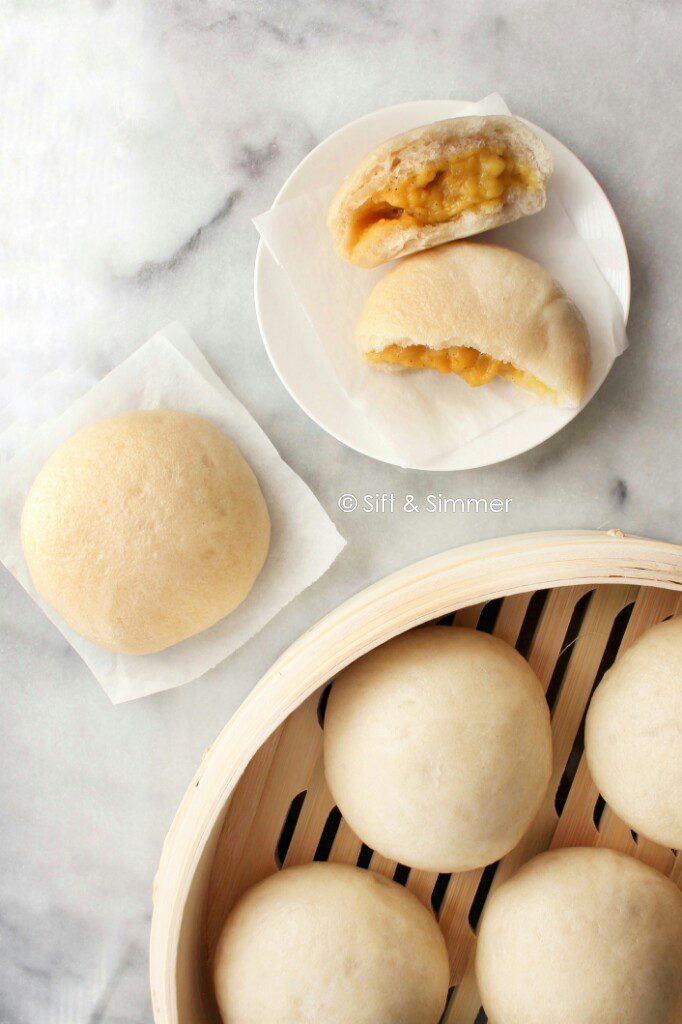 Custard Buns Lai Wong Bao in bamboo steamer and white plate.