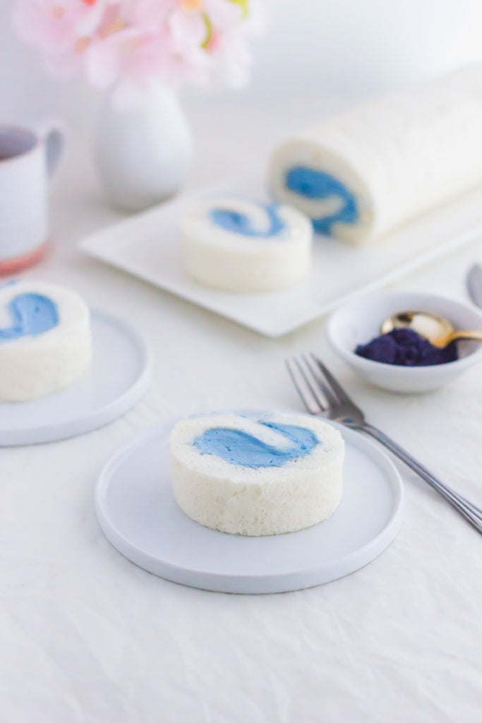White and Blue Butterfly Roll Cake on small white plate.