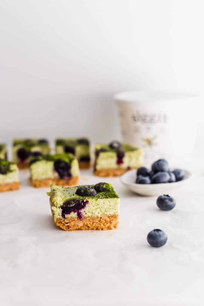 Matcha blueberry cheesecake bar with blueberries on side, siggi's yogurt container in background.