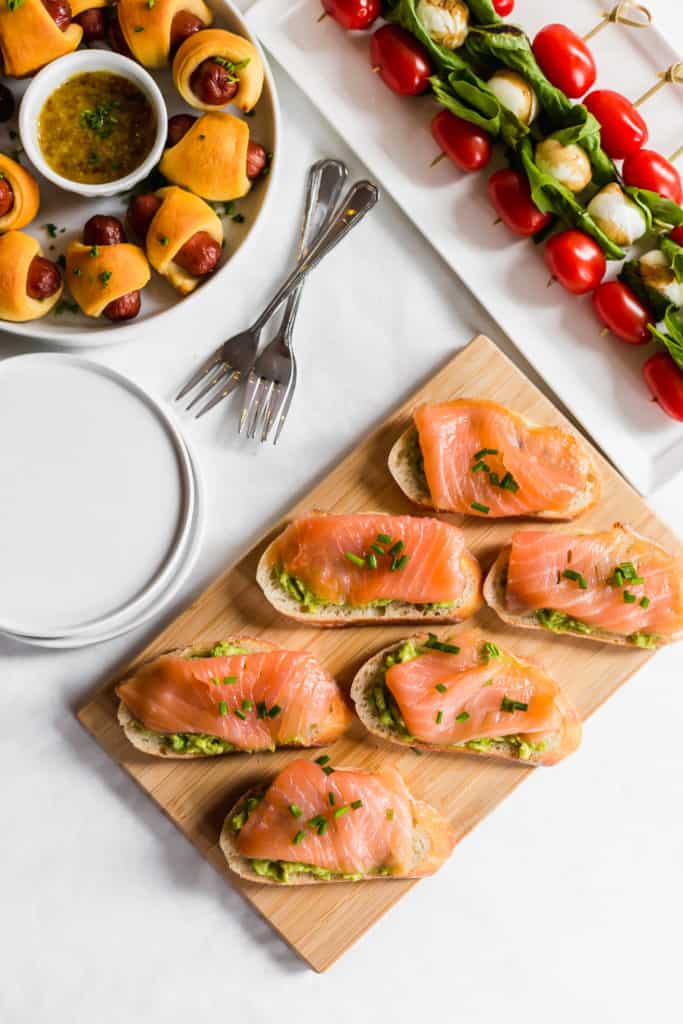 Close up of salmon crostini on wooden board.