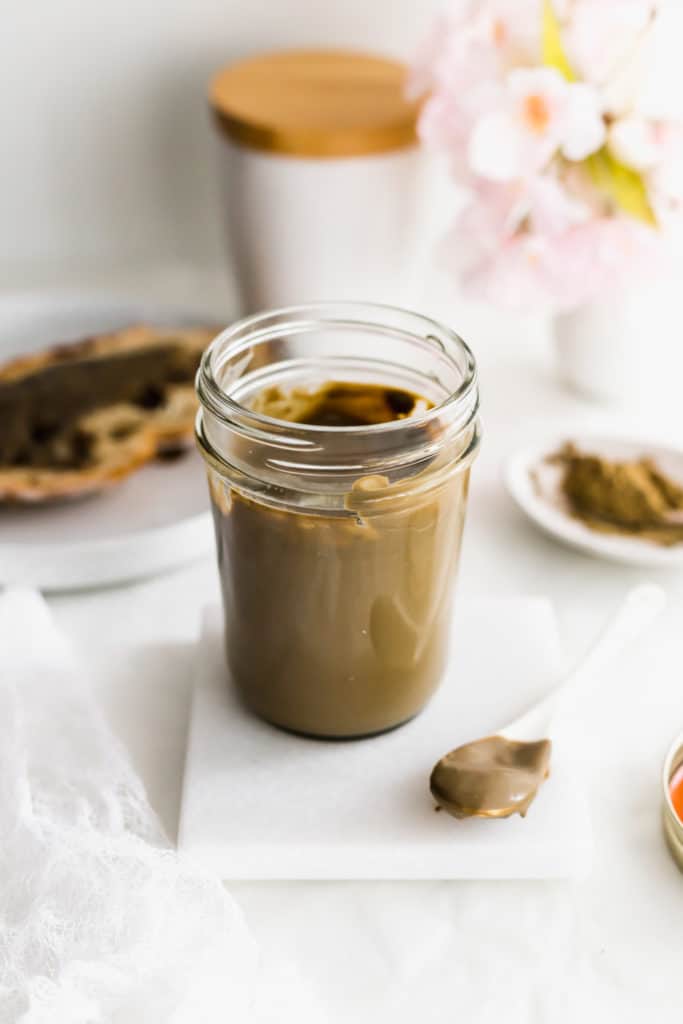 Jar of Hojicha Roasted Green Tea Milk Jam, with spoonful on side.