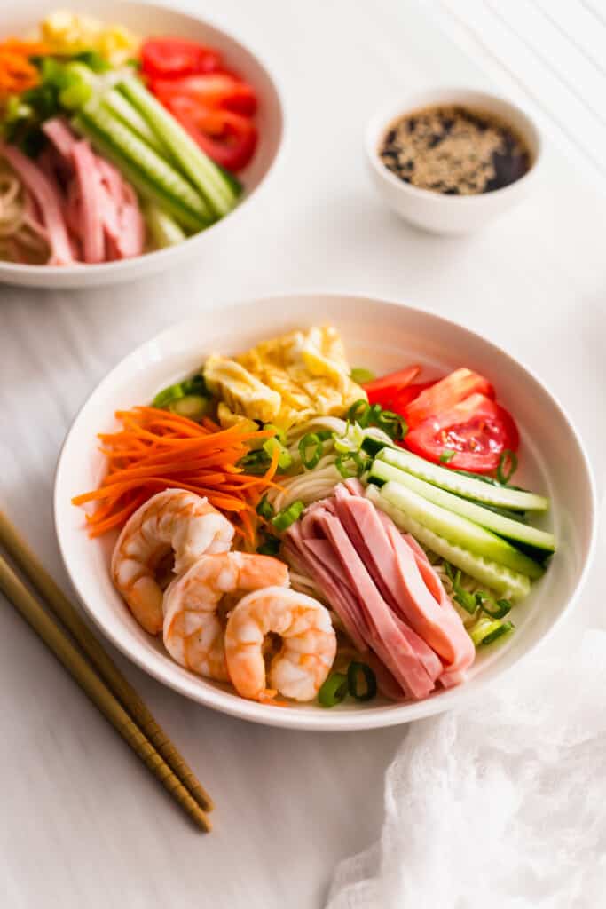 Hiyashi Chuka Cold Ramen Noodles in white bowl with chopsticks on side.