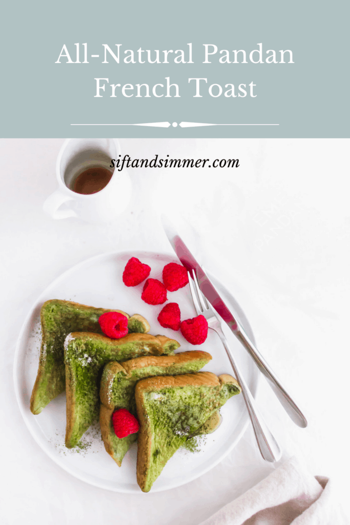 Close up of Pandan French Toast on round white plate with raspberries and fork with text overlay.
