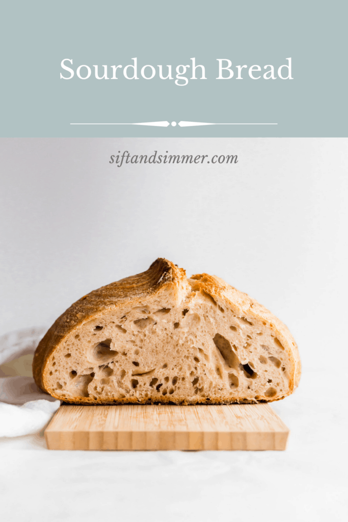 A cut sourdough bread loaf on top of wooden board with text overlay.