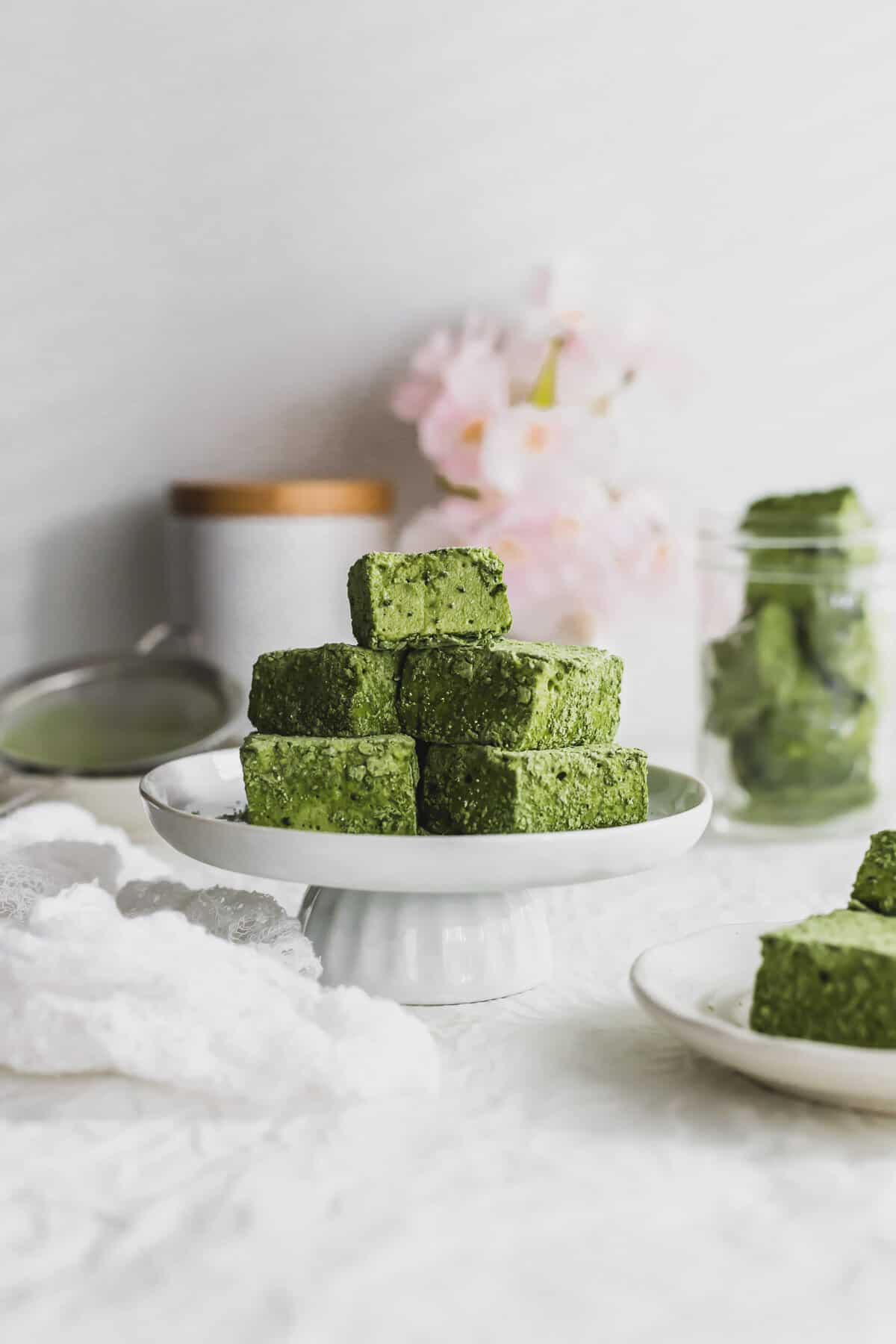 Pile of cut Matcha marshmallows on a mini pedestal.