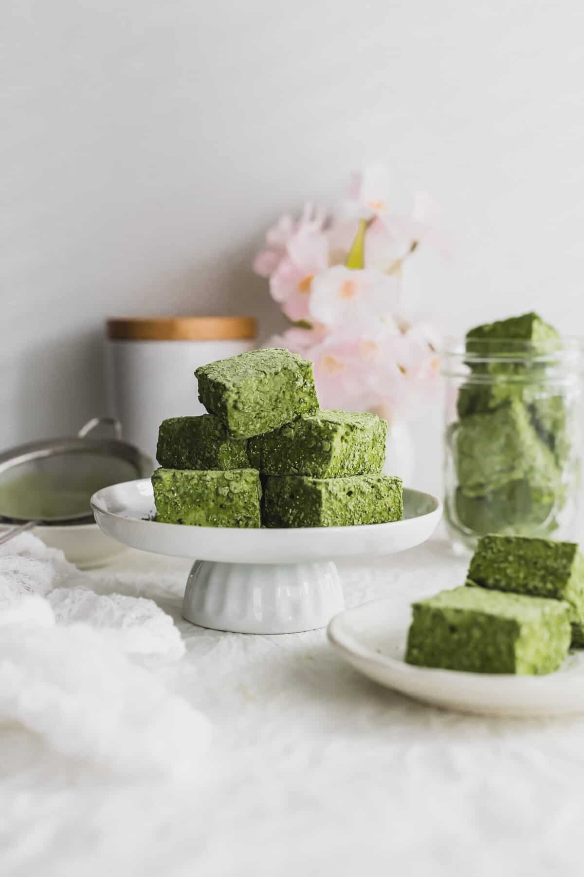 Pile of cut Matcha marshmallows on a mini pedestal.