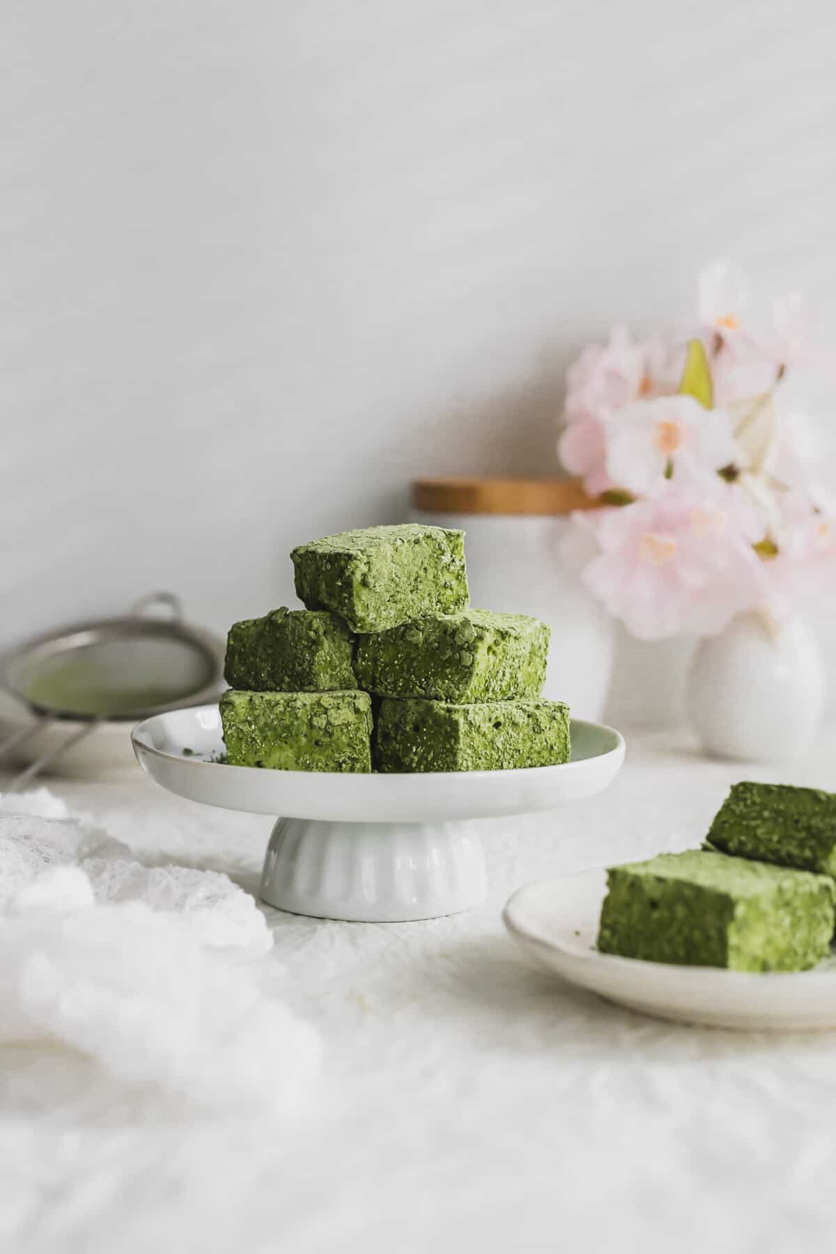 Pile of cut Matcha marshmallows on a mini pedestal.