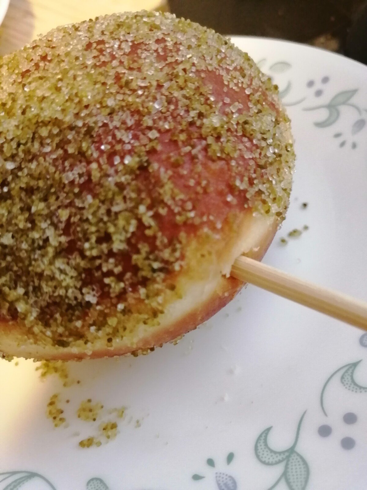 Wooden skewer poking hole in donut.