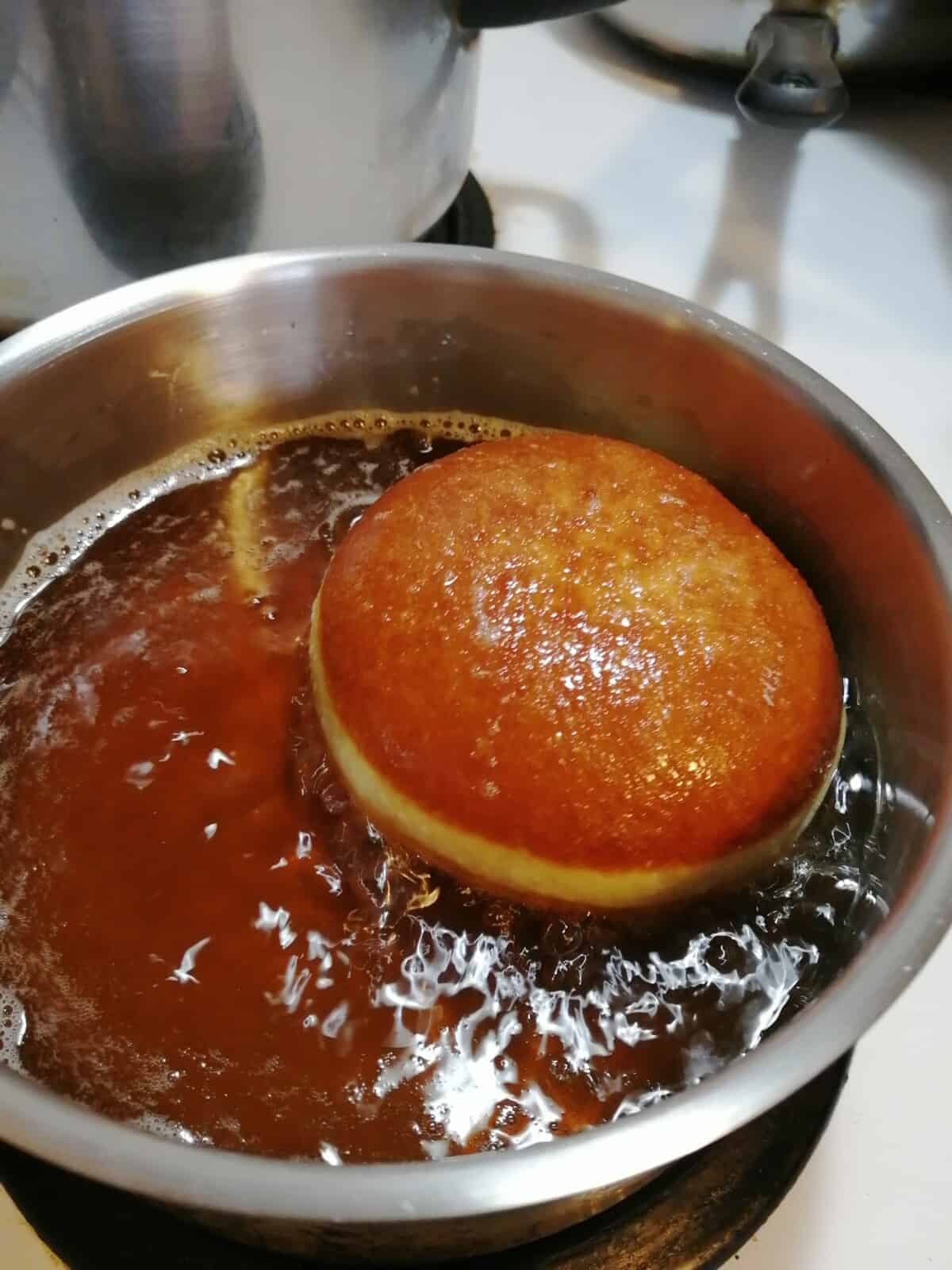 Flipped doughnut in frying oil.