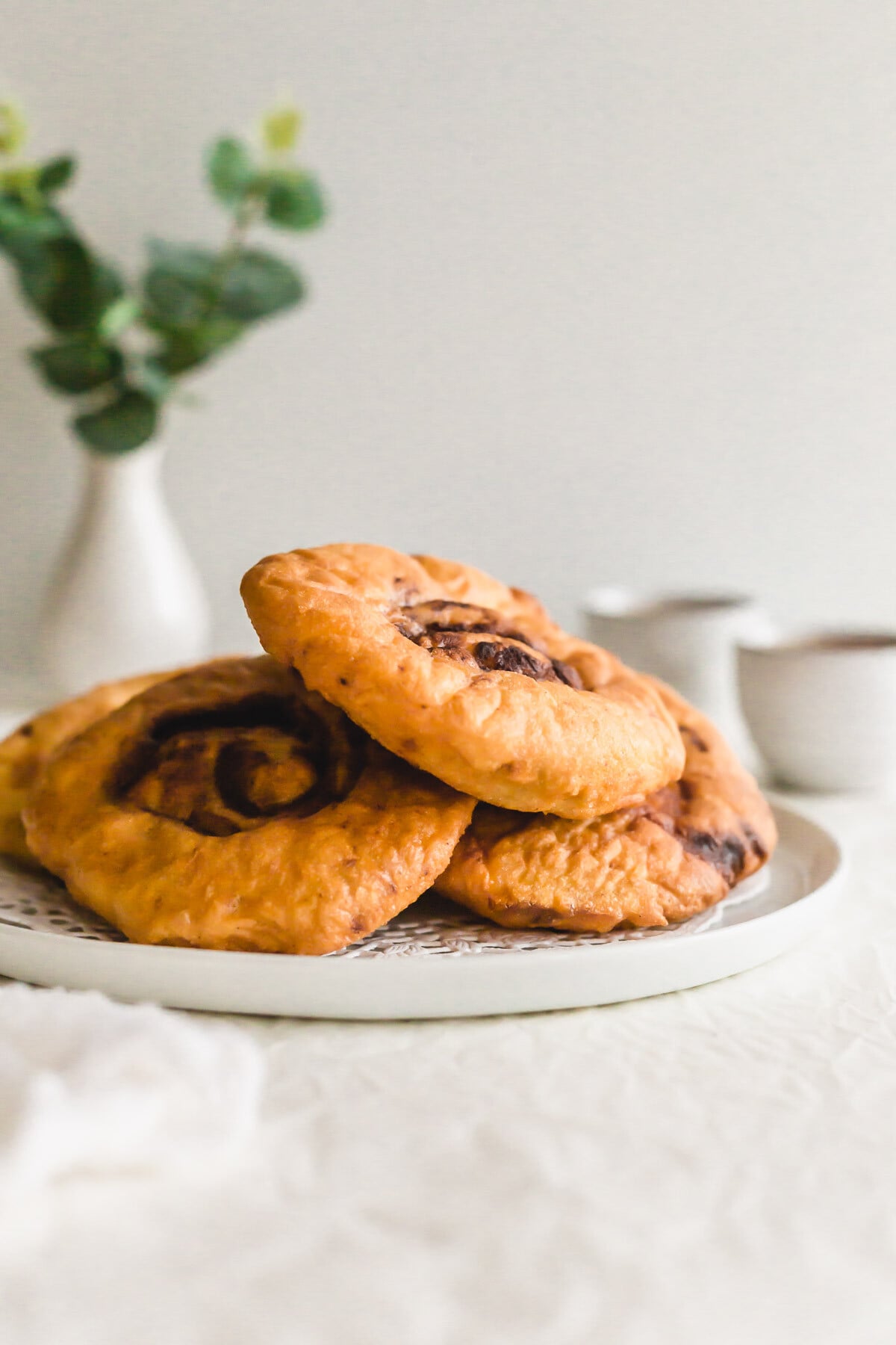 Stack of fried ham chim peng on a white plate.