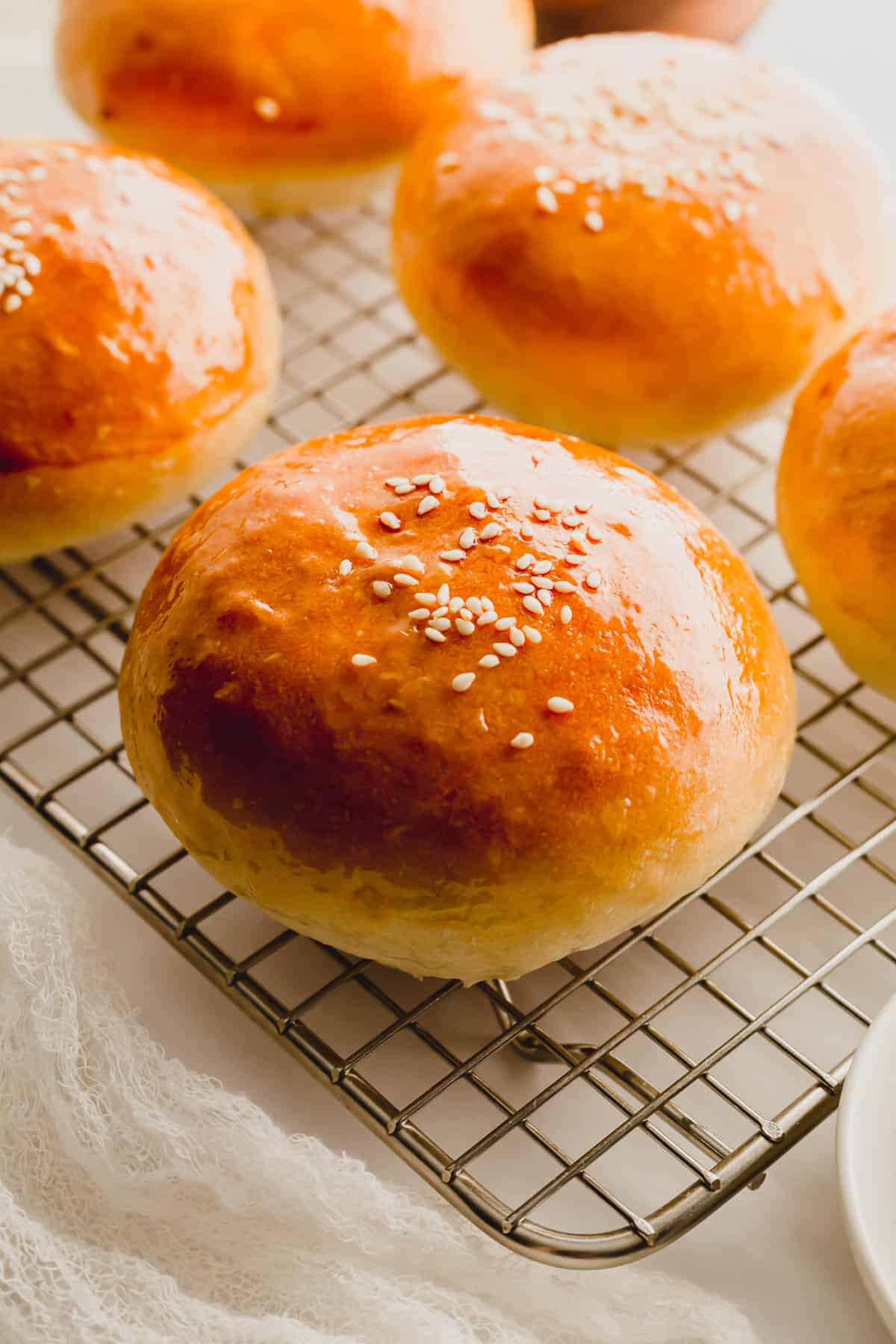 Chinese BBQ pork buns on a wire rack.