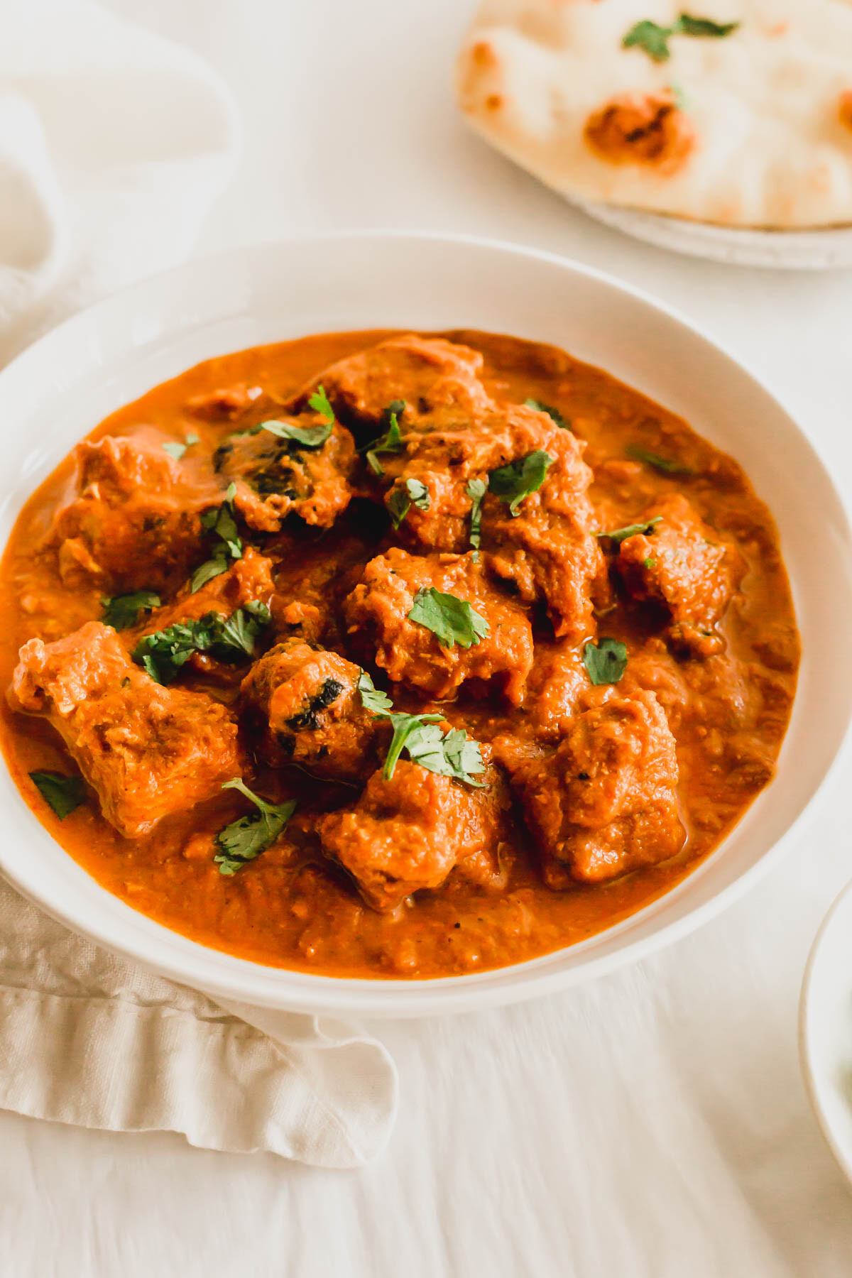 Chicken tikka masala in a white dish.