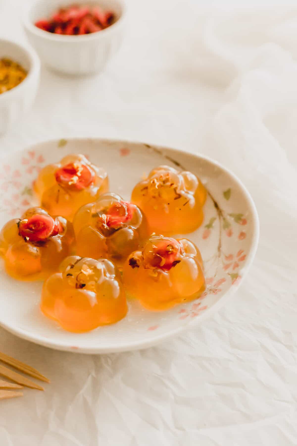 Osmanthus flower jellies on a flowered plate.