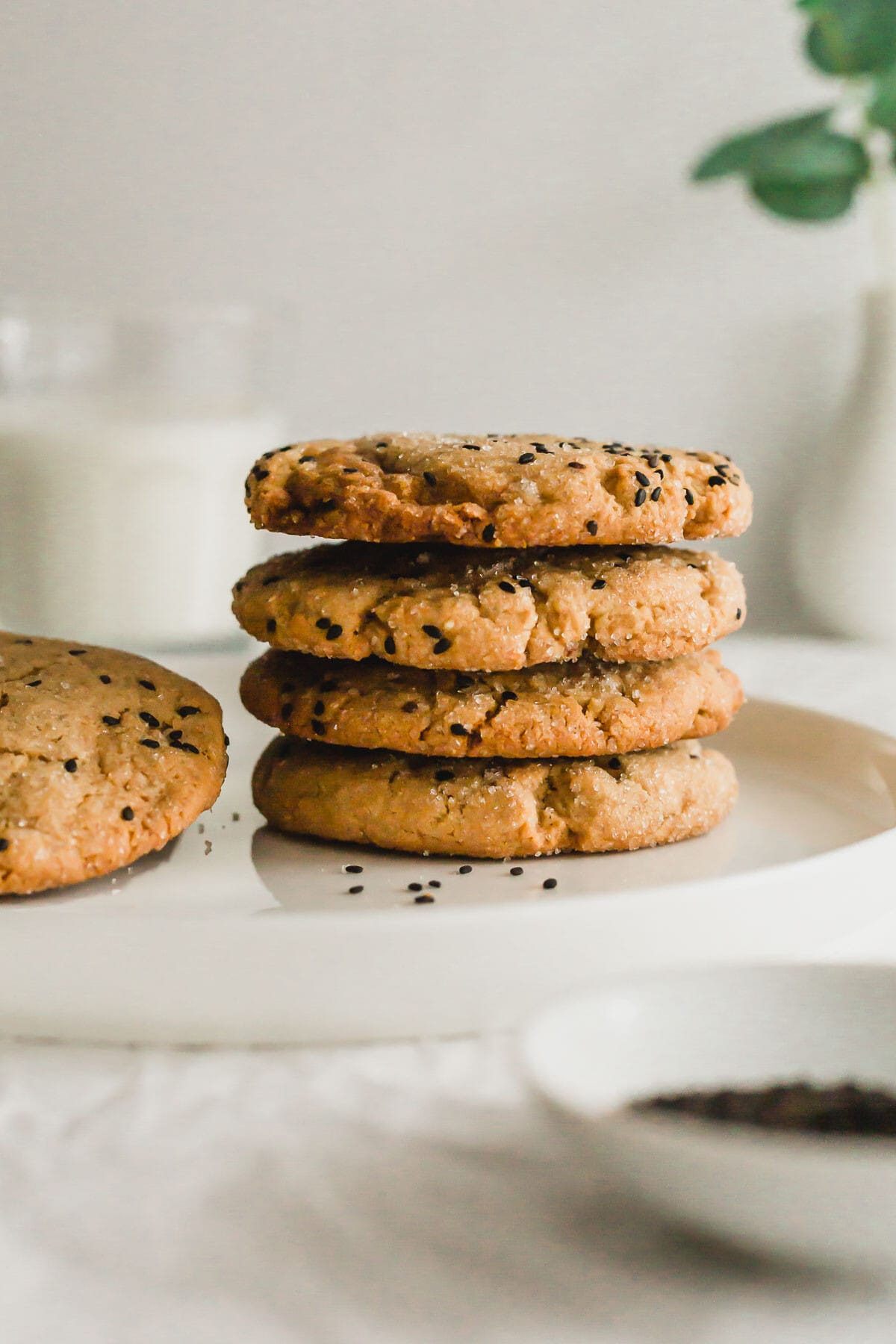 Stack of tahini miso cookies on white plate.