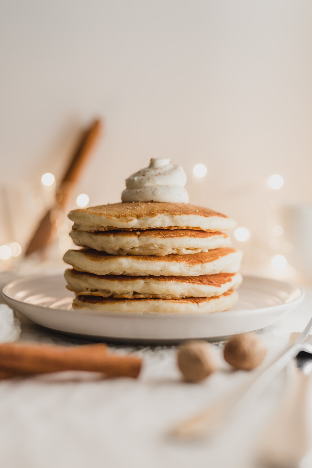 Pile of eggnog pancakes on a plate.