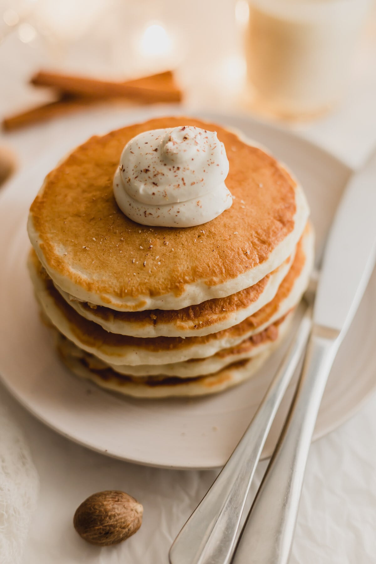 Pile of eggnog pancakes on a plate.