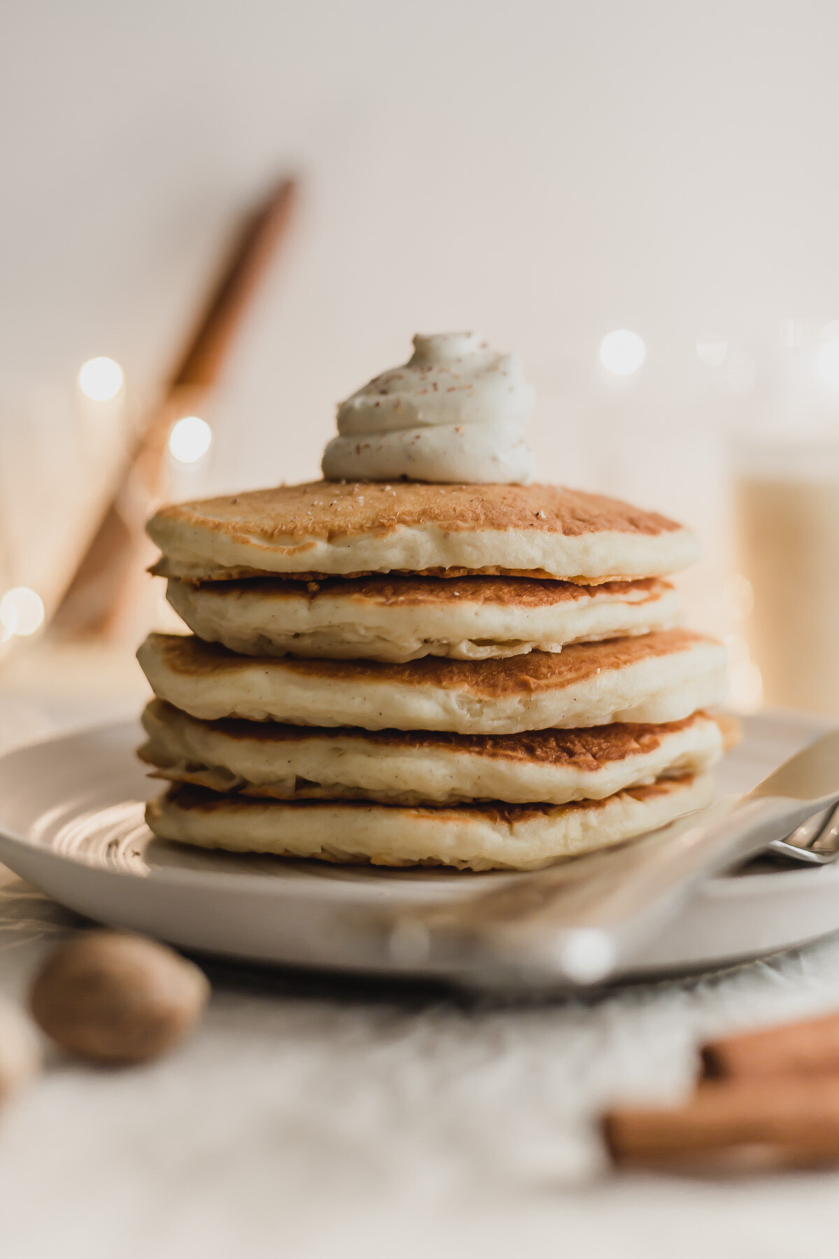 Pile of eggnog pancakes on a plate.