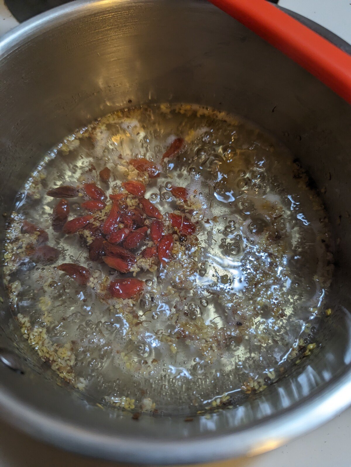 Simmering the agar mixture in a pot.