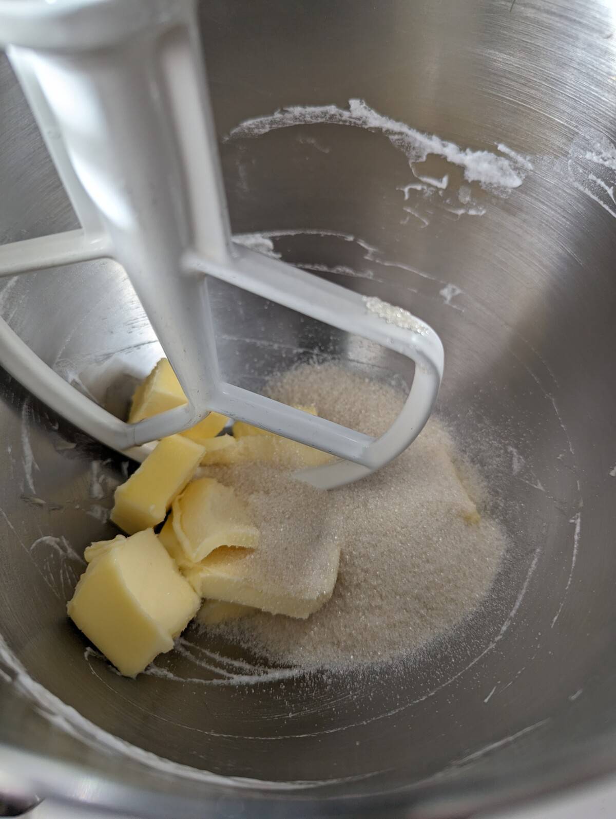 Butter and sugar in a metal stand mixer bowl, with flat beater.