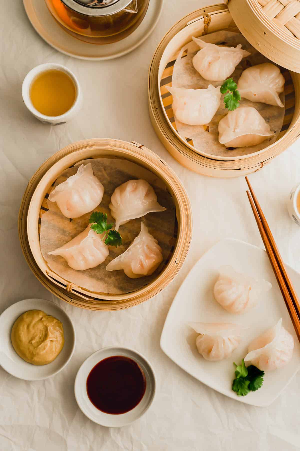 Steamed shrimp har gow dumplings in bamboo steamers. 