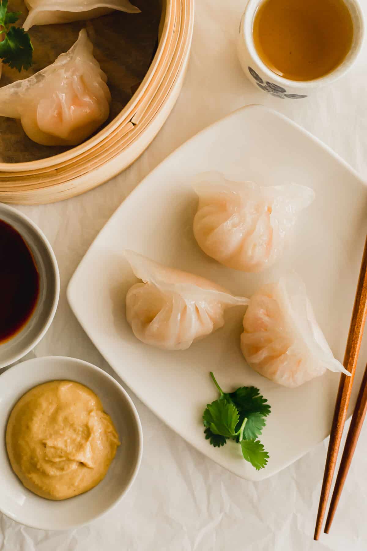 Steamed shrimp dumplings on a white plate.