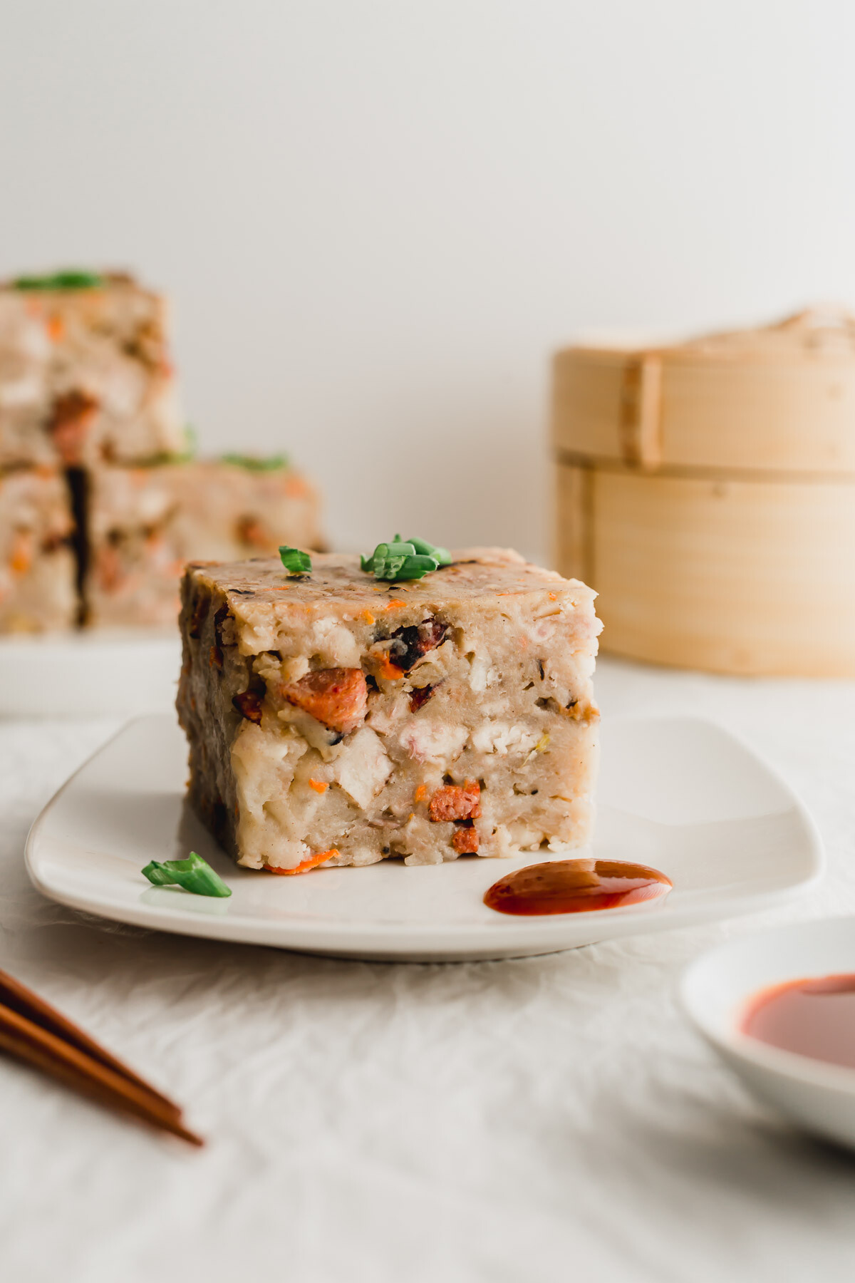 Steamed taro cake on a white plate.
