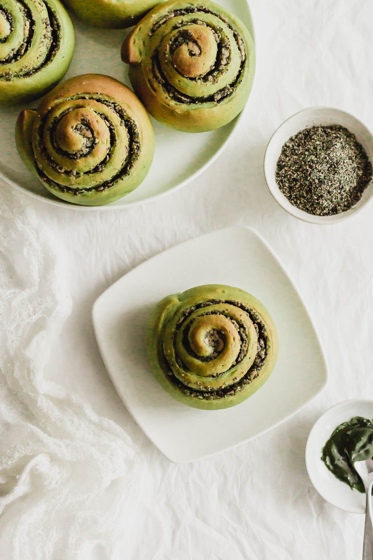 Matcha black sesame rolls on a white plates.