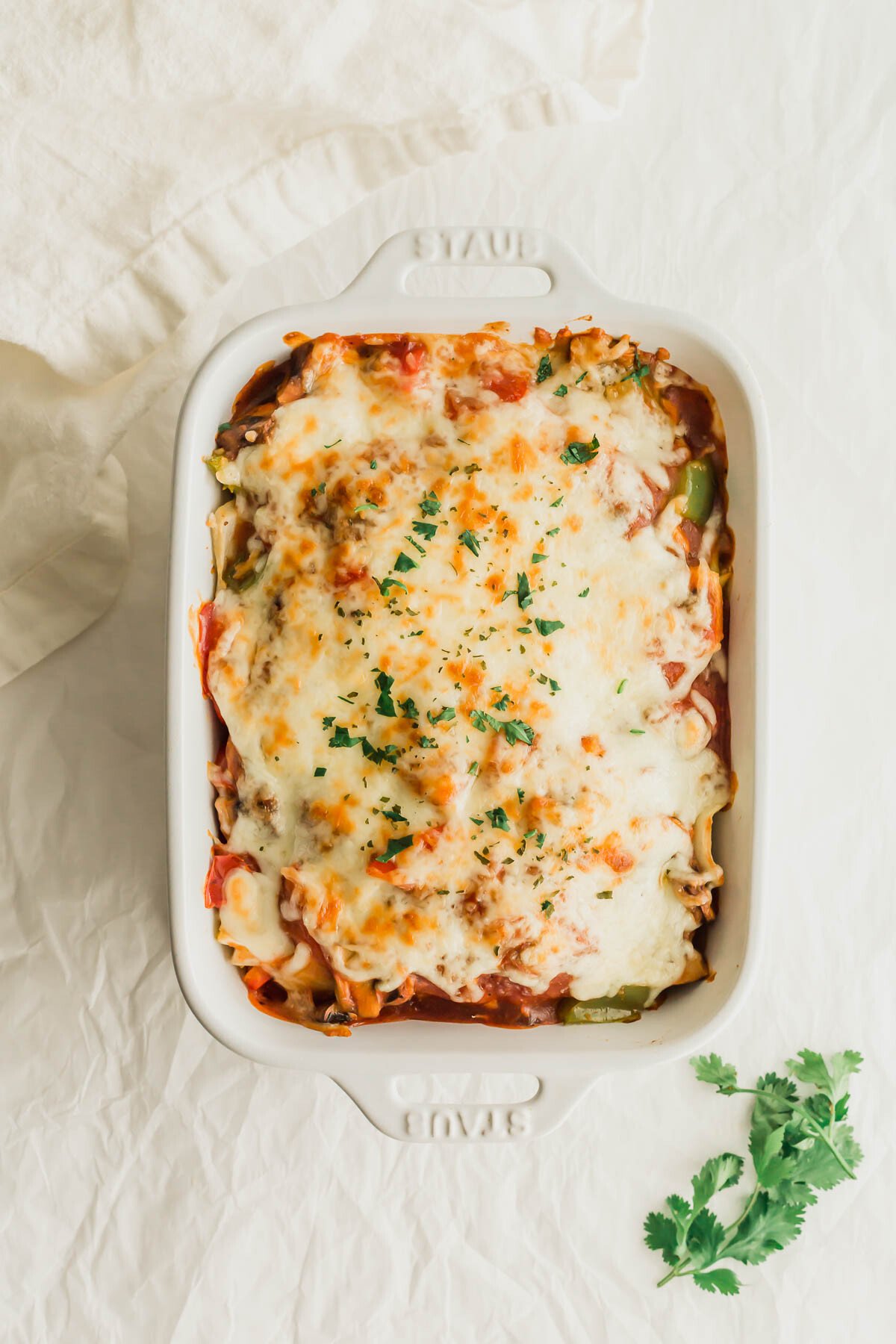 A white casserole dish of HK baked pork chops covered with melted cheese.
