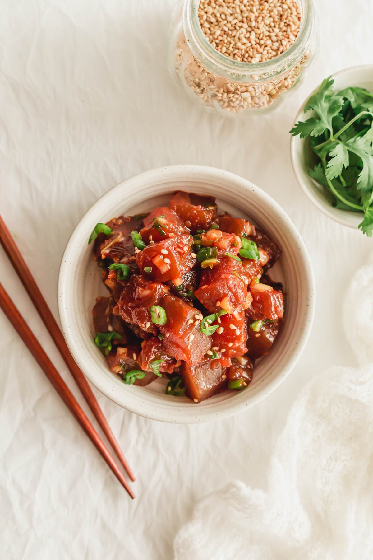 Spicy tuna poke in a white bowl.