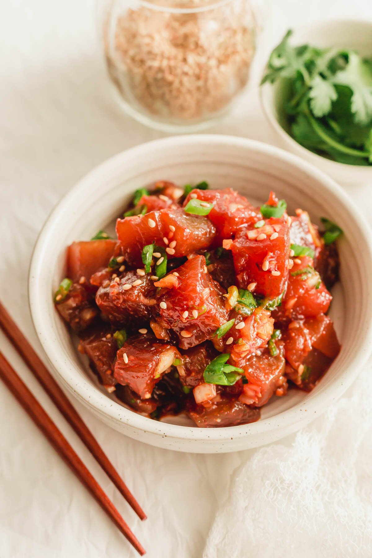 Spicy tuna poke in a white bowl.