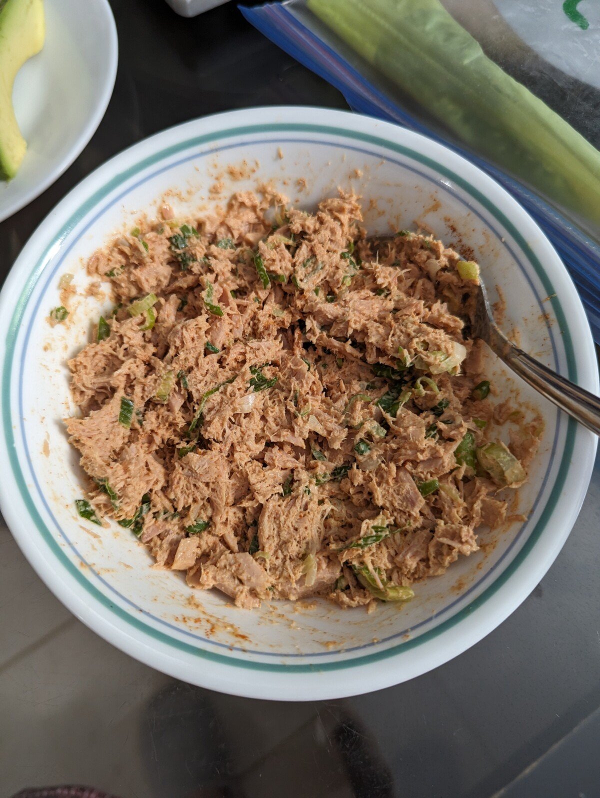 Spicy tuna mixture in a white bowl with spoon.