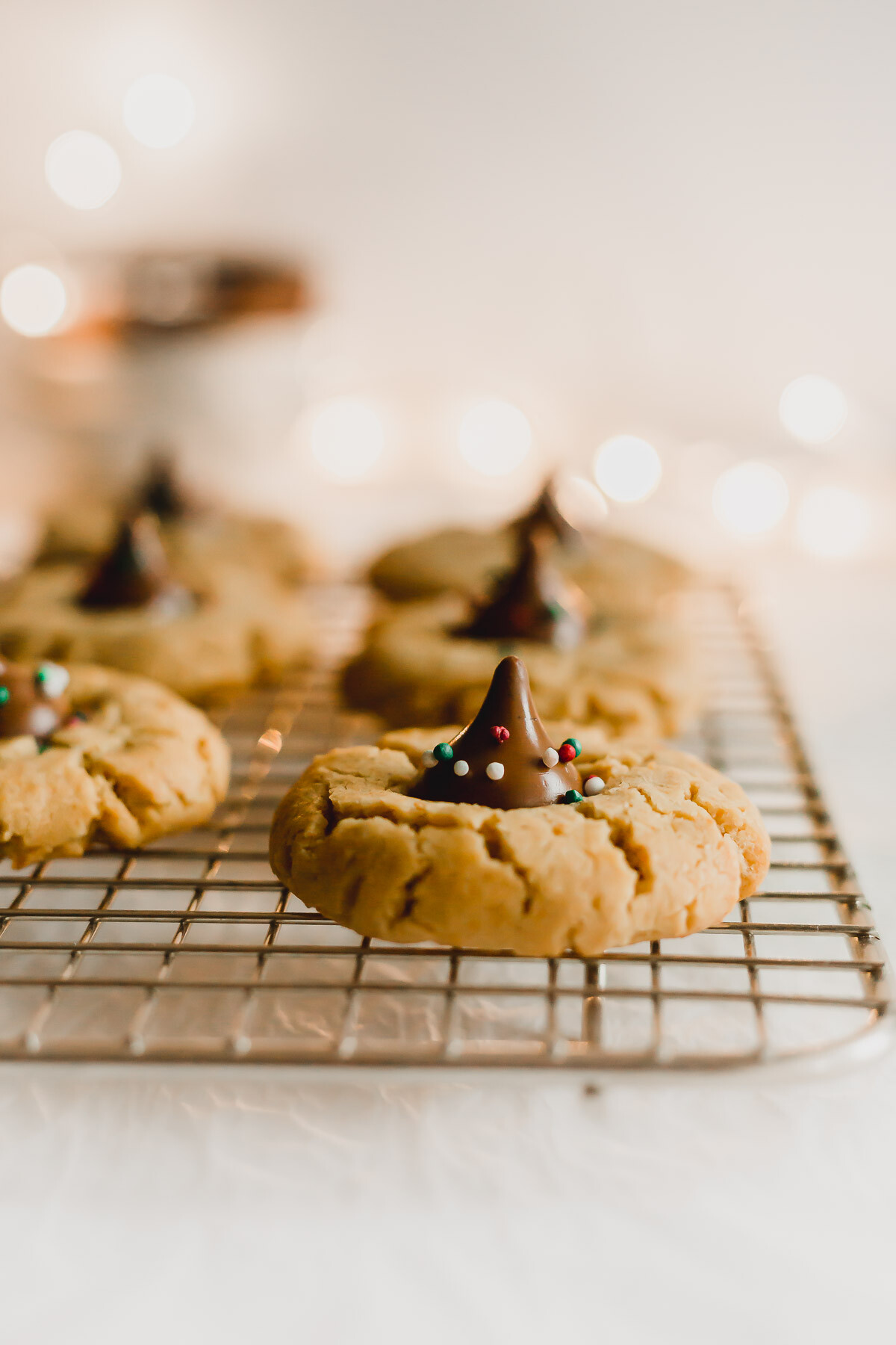 Peanut butter blossom cookies on a wire rack.