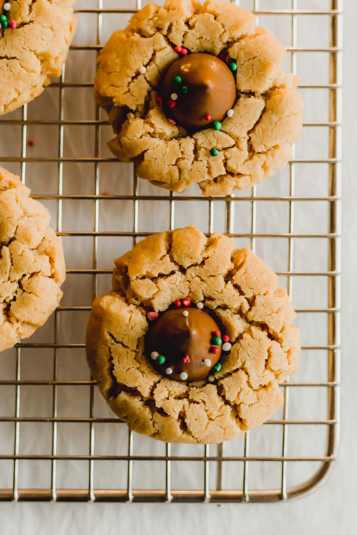 Peanut butter blossom cookies on a wire rack.