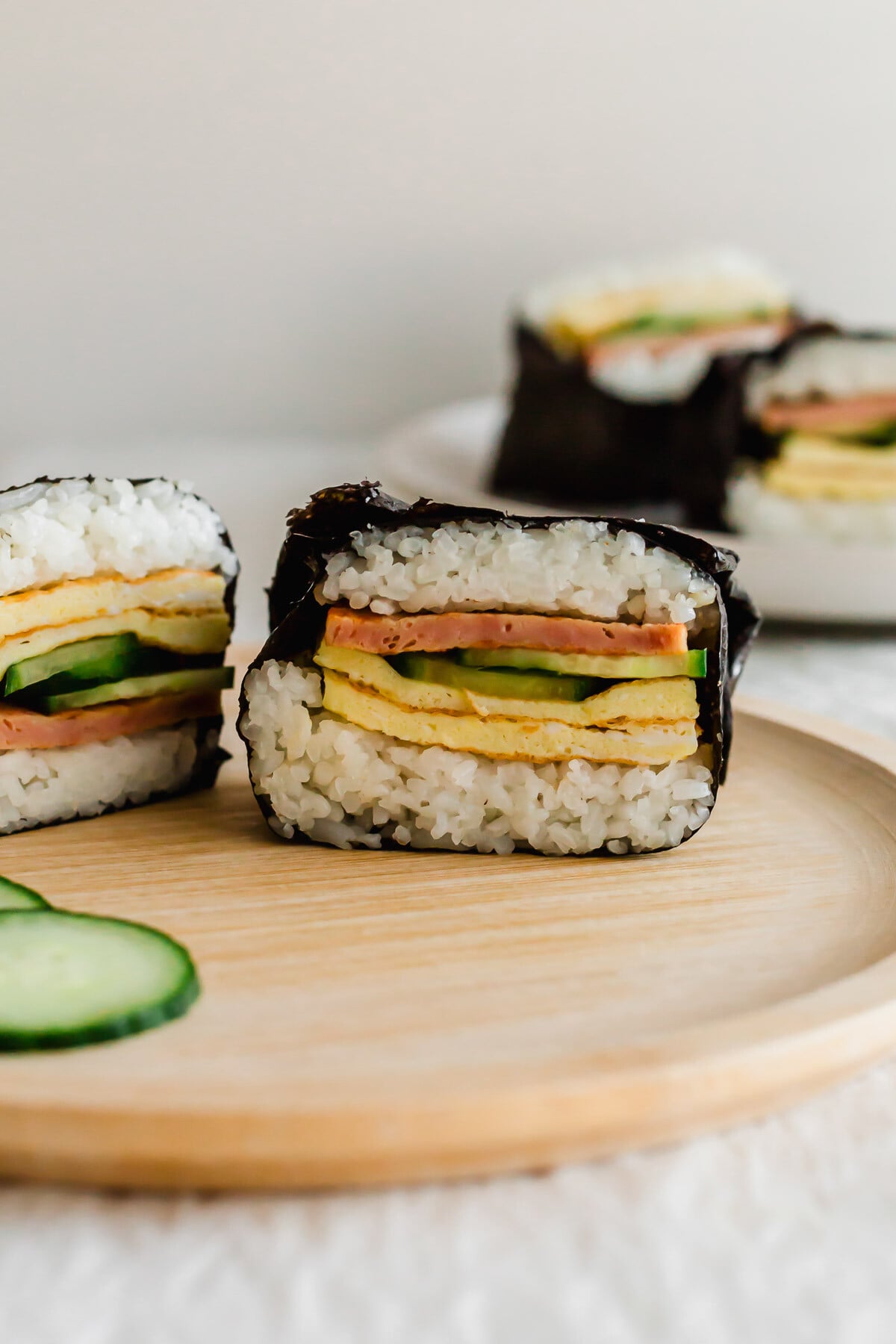 Cut Onigirazu on a wooden plate.