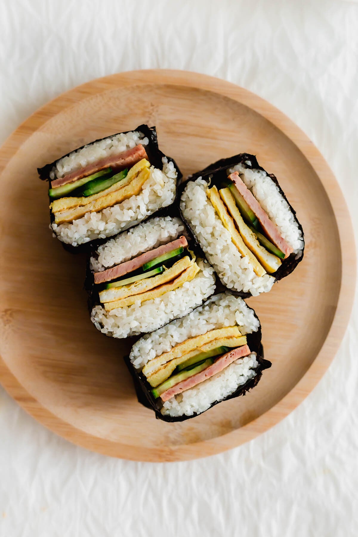 Cut Onigirazu on a wooden plate.