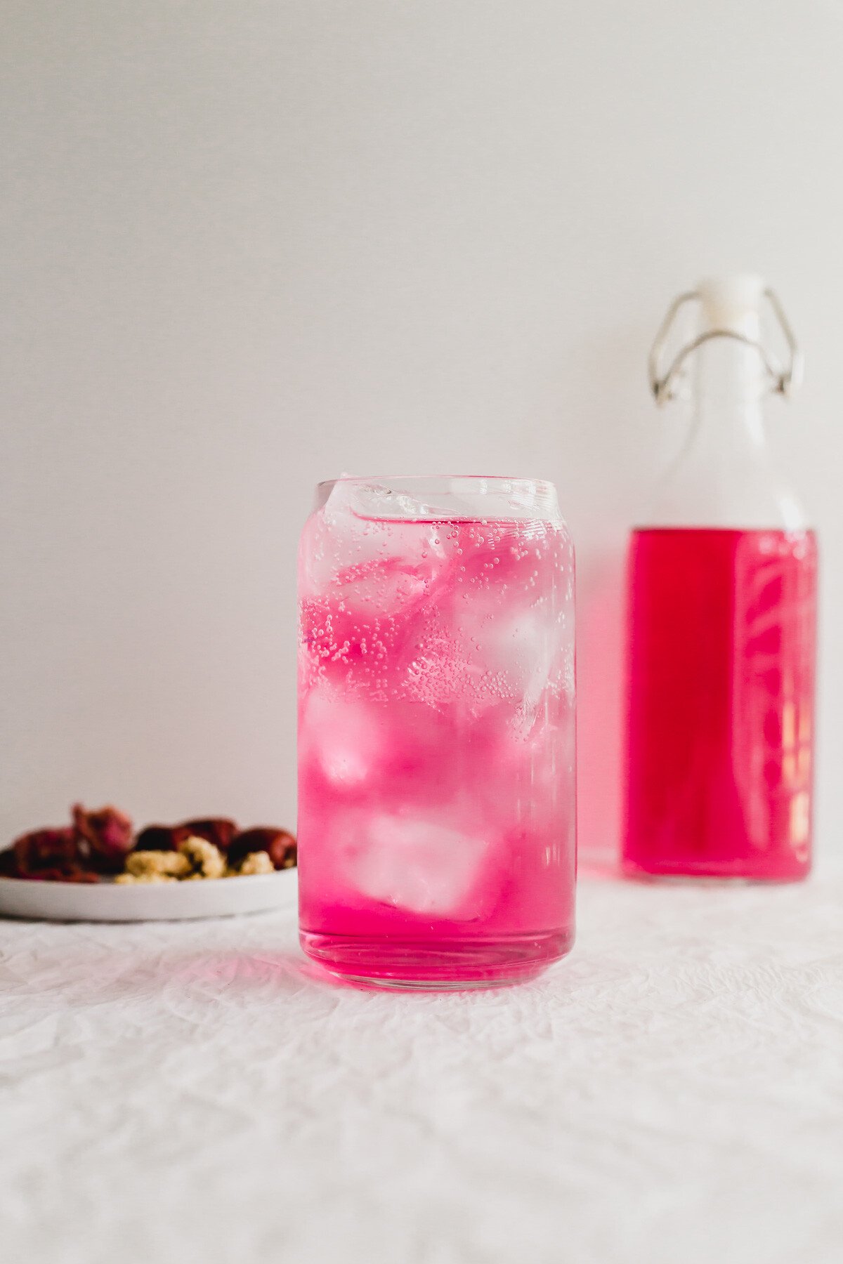 Pink Chrysanthemum and goji berry sparkling tea in a glass.