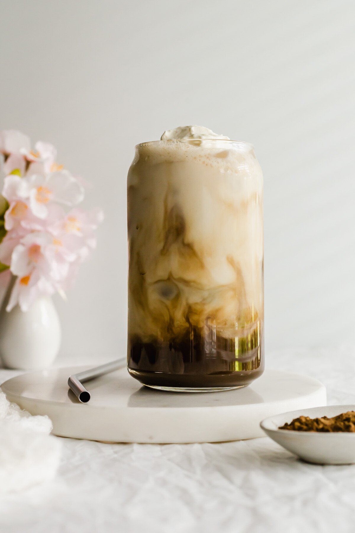 Iced Hojicha Latte in a glass with straw on the side.