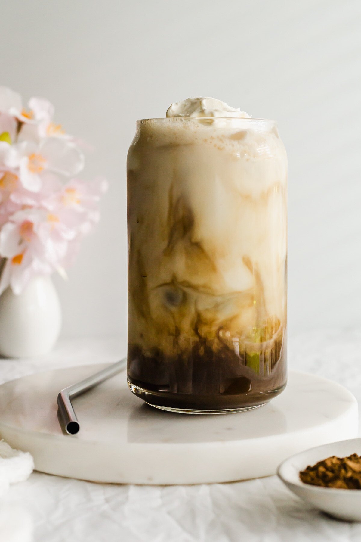 Iced Hojicha Latte in a glass with straw on the side.