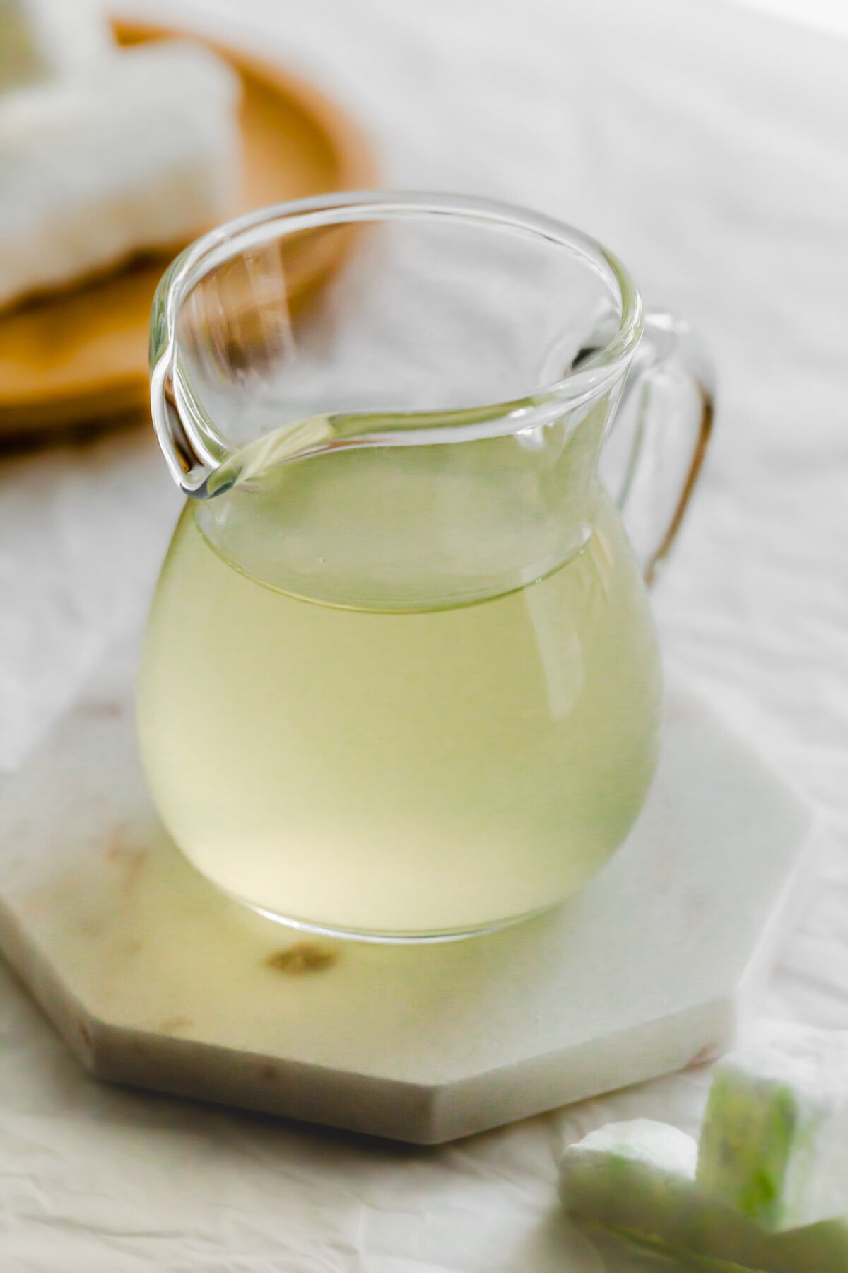 Wintermelon syrup in a glass pitcher.