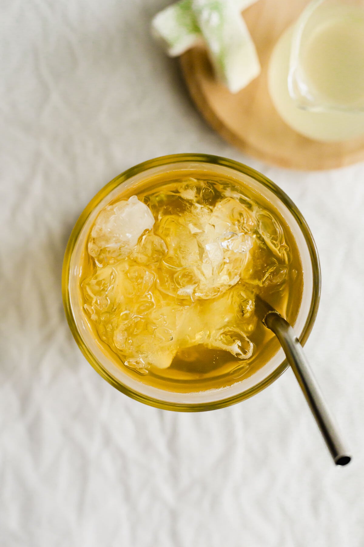 Wintermelon green tea in a glass with metal straw.