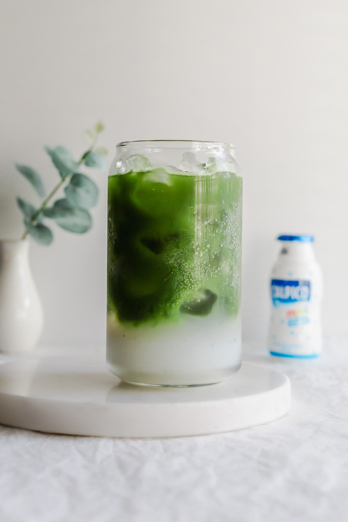 Matcha layered with Calpis in a glass.