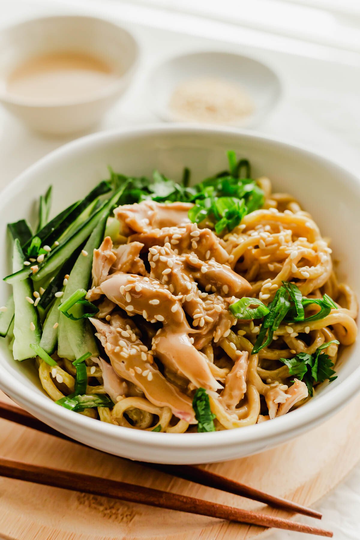 Chinese cold sesame noodles in a white bowl.