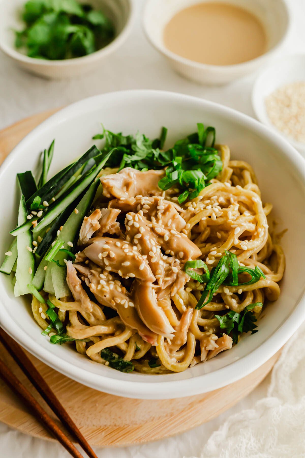 Chinese cold sesame noodles in a white bowl.