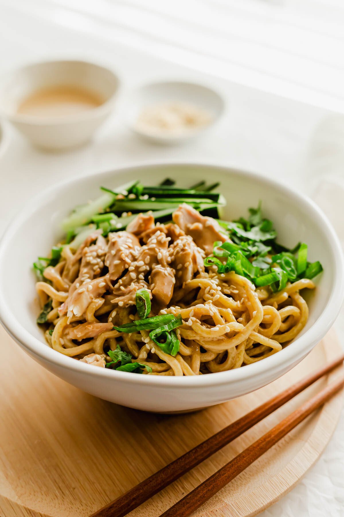 Chinese cold sesame noodles in a white bowl.