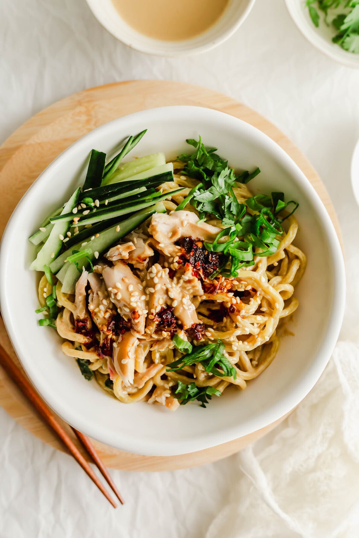 Chinese cold sesame noodles in a white bowl.