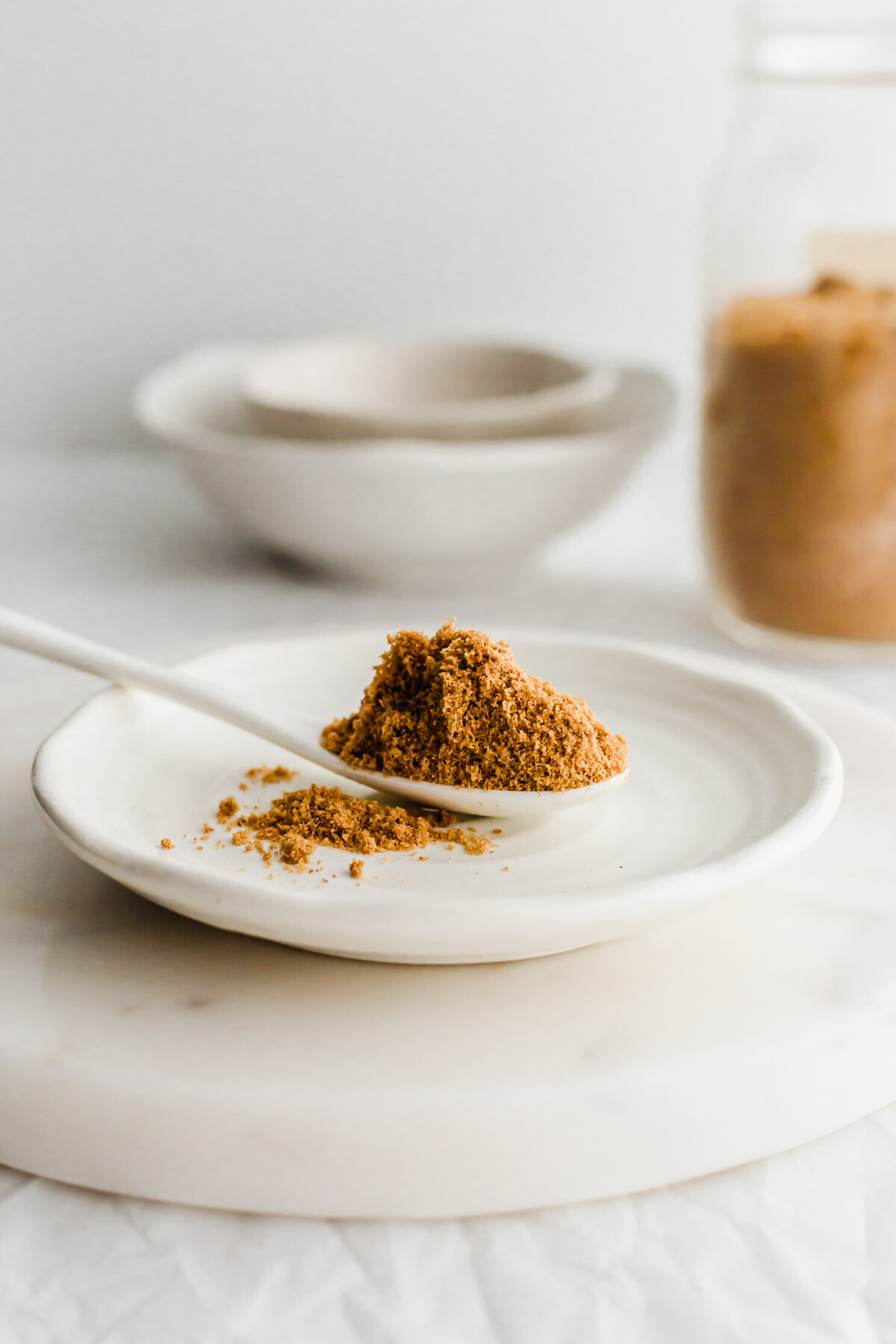 A white spoon filled with Chinese fish flounder powder.