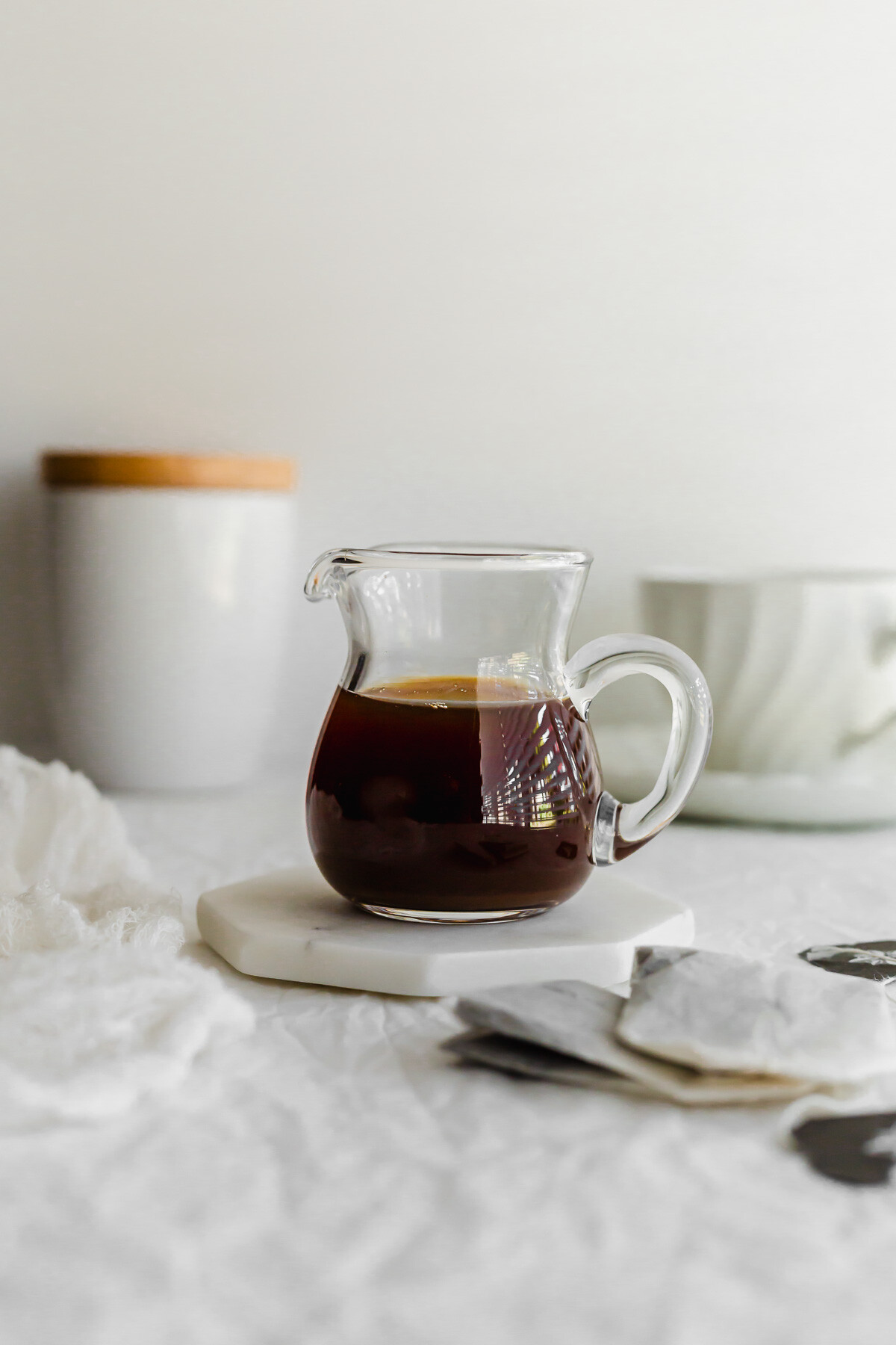 Earl grey syrup in a glass pitcher.